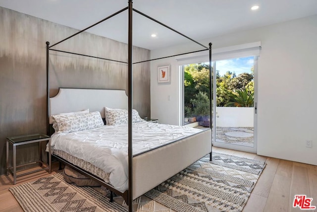 bedroom featuring hardwood / wood-style floors and access to exterior