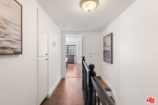 corridor with dark hardwood / wood-style flooring