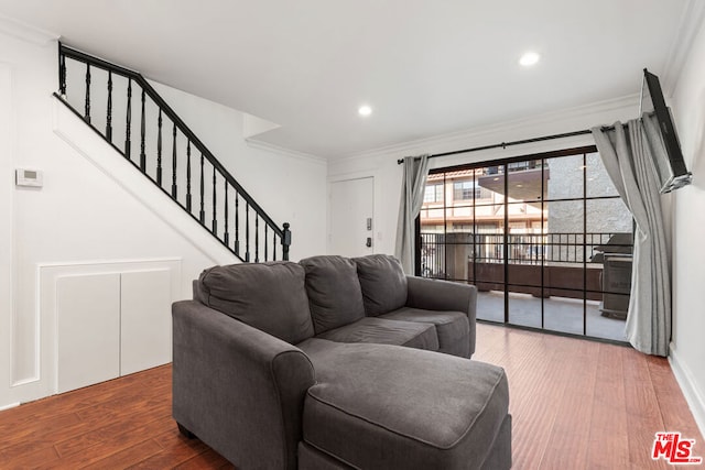 living room featuring crown molding and dark wood-type flooring