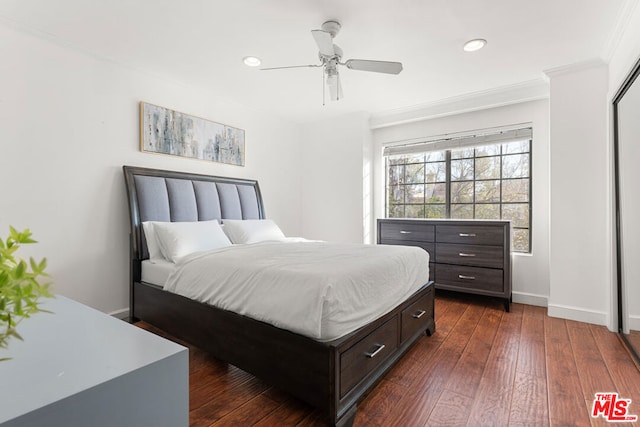 bedroom with crown molding, dark wood-type flooring, and ceiling fan