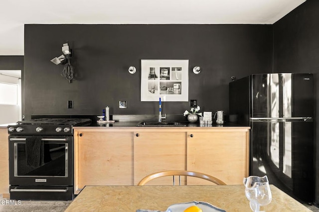 kitchen featuring sink and black appliances