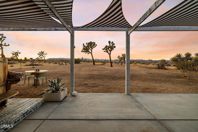 view of patio terrace at dusk