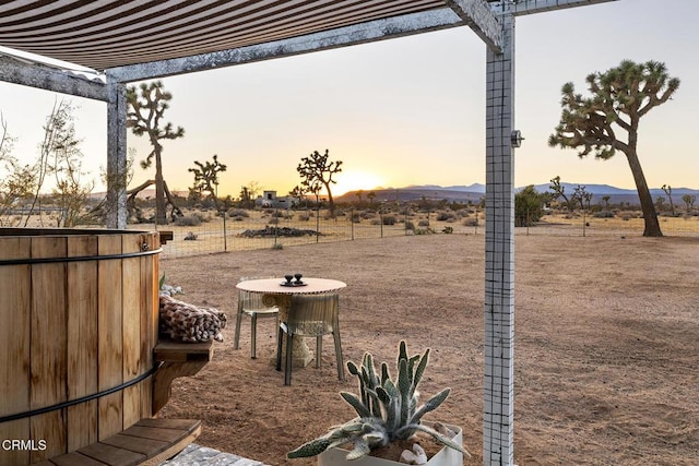 yard at dusk featuring a mountain view