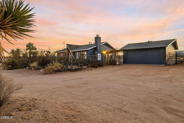 view of front of property featuring an outdoor structure and fence