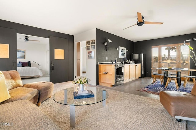 living area featuring finished concrete floors and a ceiling fan