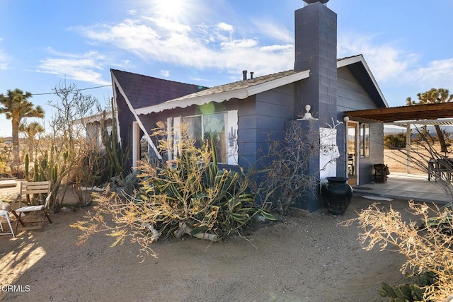 view of side of property featuring a chimney