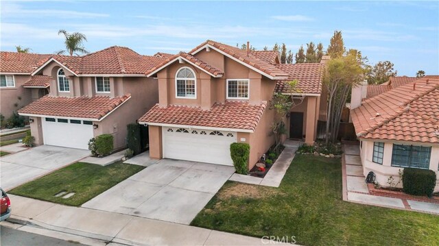 view of front of property featuring a garage and a front lawn