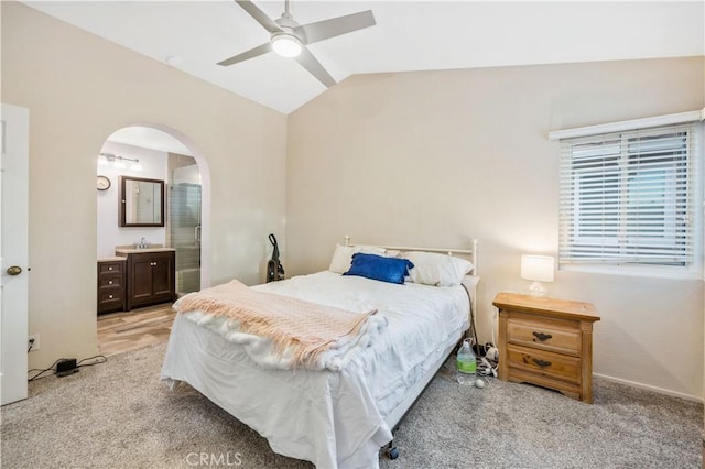 carpeted bedroom featuring lofted ceiling, sink, and ceiling fan