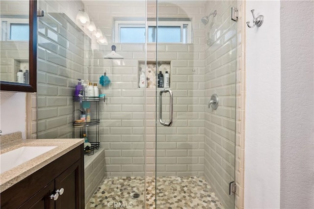 bathroom featuring vanity and an enclosed shower