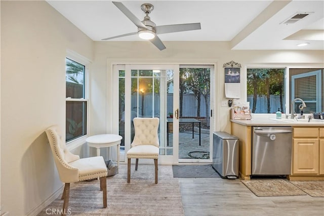 sunroom / solarium with sink and ceiling fan