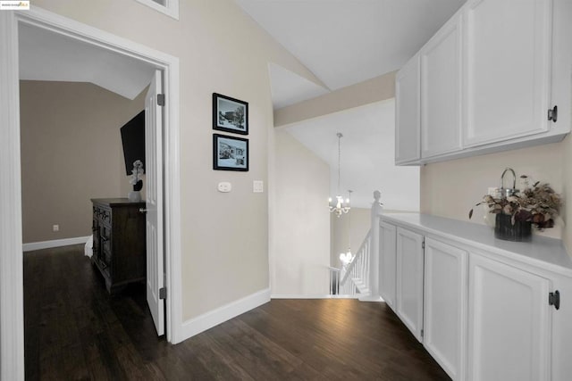 washroom with an inviting chandelier and dark hardwood / wood-style floors