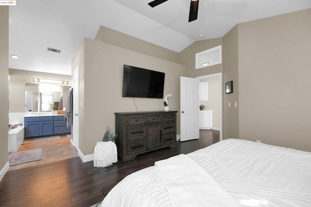 bedroom with dark hardwood / wood-style flooring, connected bathroom, lofted ceiling, and ceiling fan