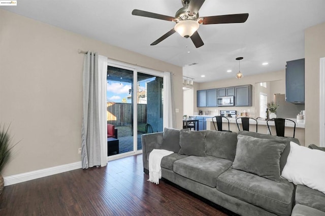 living room with dark hardwood / wood-style floors and ceiling fan