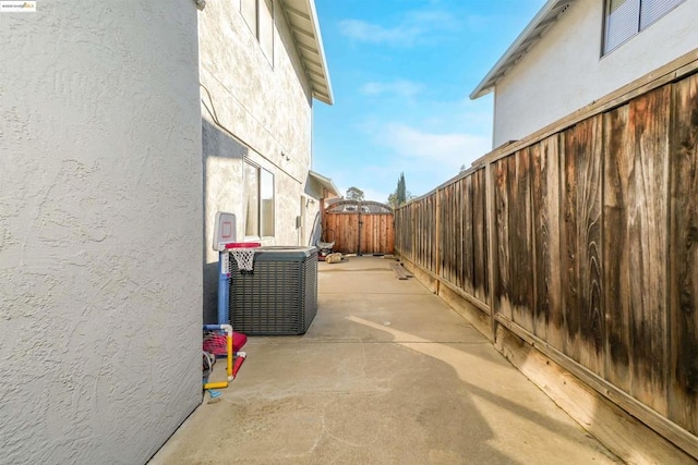 view of side of property featuring cooling unit and a patio area