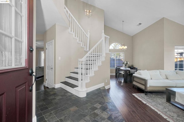 foyer featuring dark wood-type flooring and a chandelier