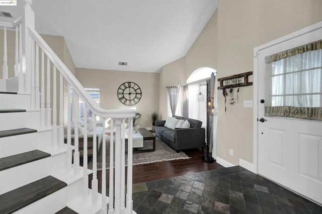 foyer entrance featuring lofted ceiling and a wealth of natural light