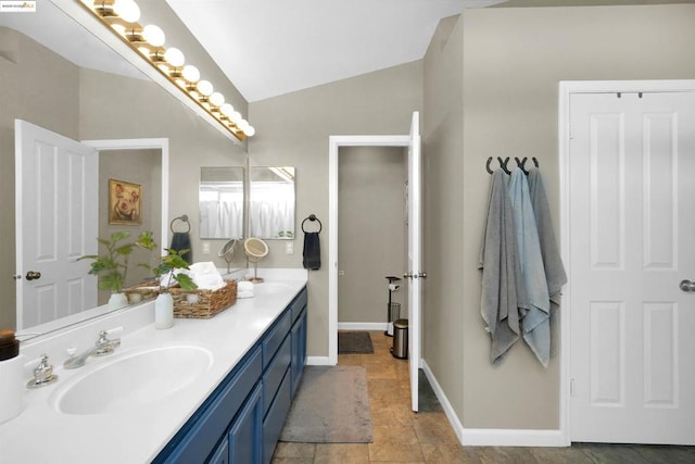 bathroom with vaulted ceiling and vanity