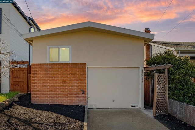 property exterior at dusk featuring a garage