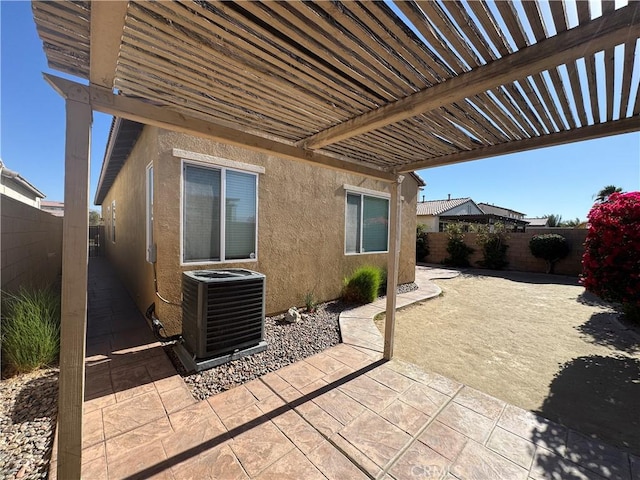 view of patio featuring central AC unit and a pergola