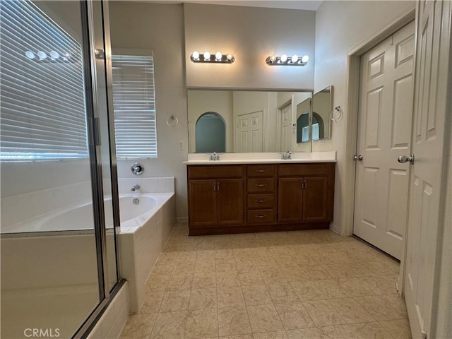 bathroom featuring plus walk in shower and vanity