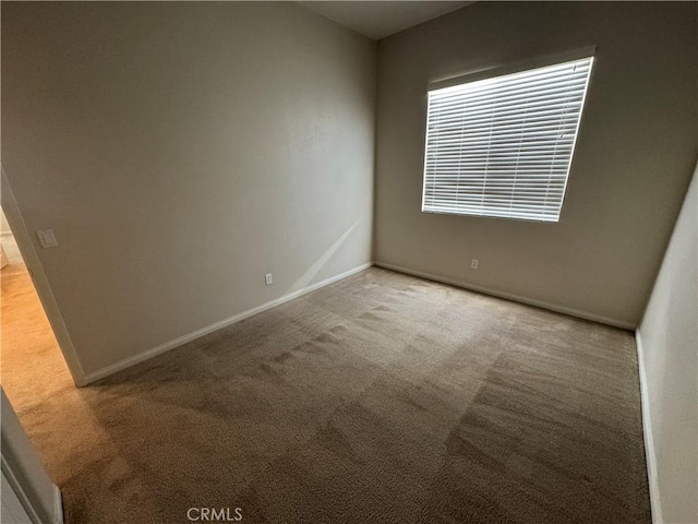 unfurnished room featuring light carpet