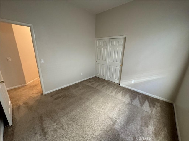 unfurnished bedroom with a closet and carpet floors