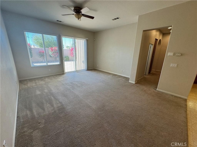 carpeted spare room with ceiling fan