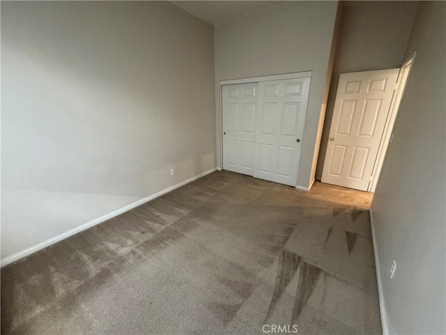 unfurnished bedroom featuring a closet and carpet flooring