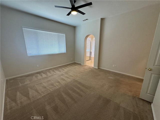 carpeted spare room with ceiling fan