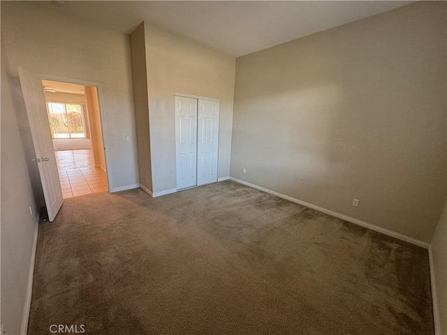 unfurnished bedroom with a closet and carpet flooring