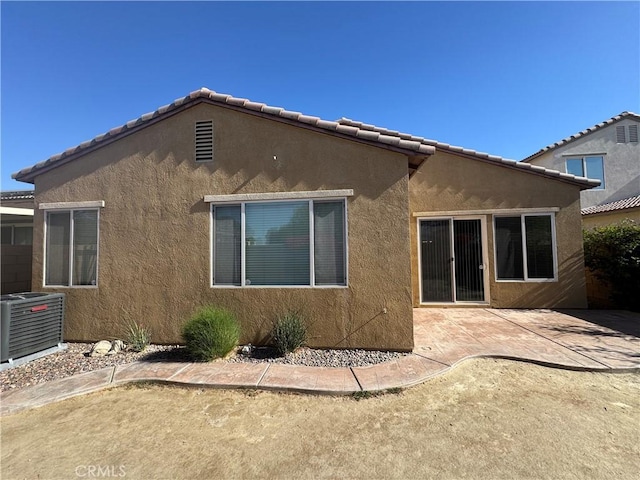 rear view of property featuring a patio area and central AC unit