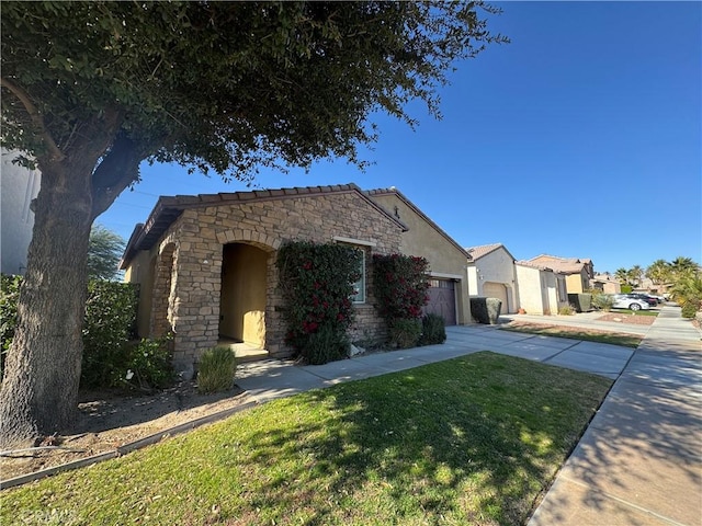 view of front of property with a garage and a front lawn