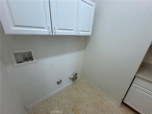 clothes washing area with gas dryer hookup, cabinets, and washer hookup