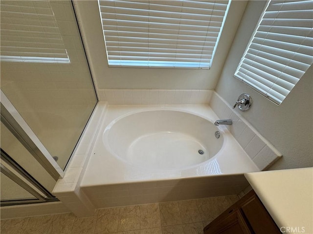 bathroom with separate shower and tub, tile patterned flooring, a wealth of natural light, and vanity