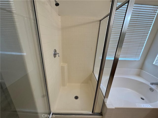 bathroom featuring plus walk in shower