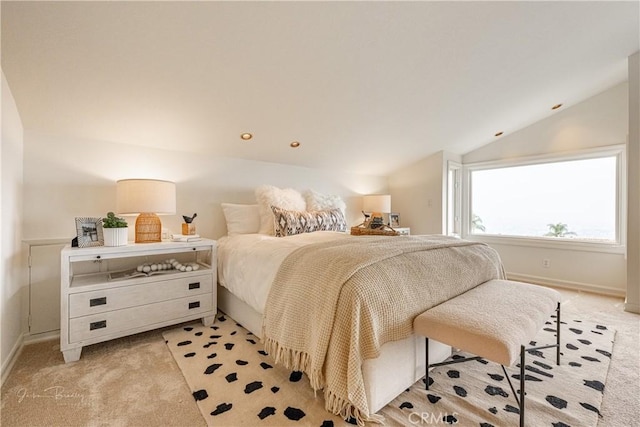 bedroom with lofted ceiling and light carpet