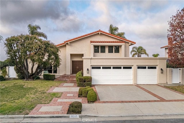 mediterranean / spanish home with a front yard