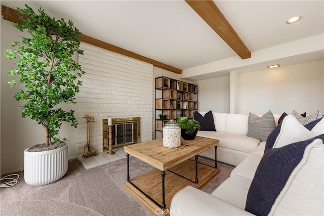 living room with a brick fireplace, carpet floors, and beam ceiling