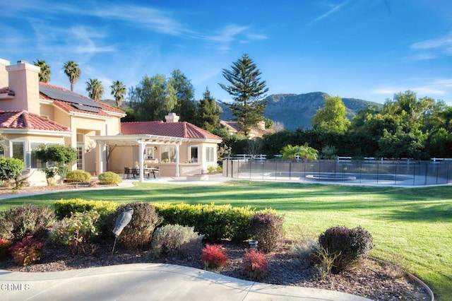 surrounding community featuring a mountain view, a yard, a patio area, and a pergola