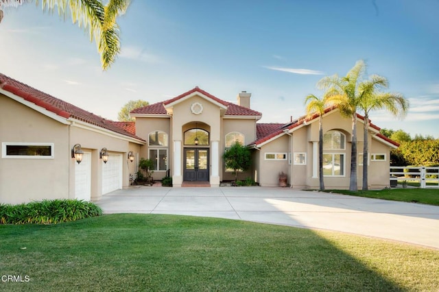 mediterranean / spanish house with french doors, stucco siding, fence, driveway, and a tiled roof