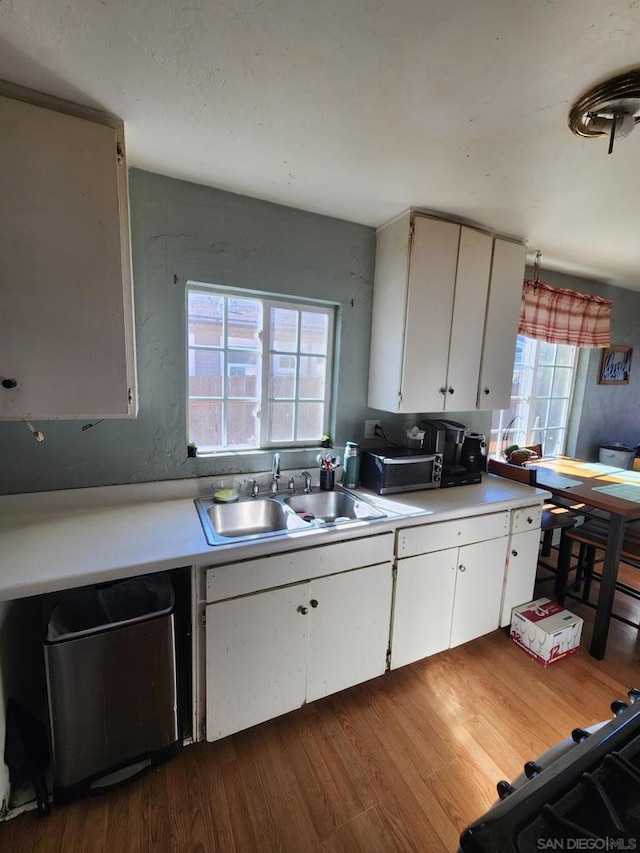 kitchen with sink, white cabinetry, dark hardwood / wood-style floors, and dishwasher