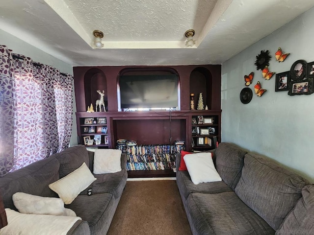 living room featuring a textured ceiling, a tray ceiling, and dark colored carpet