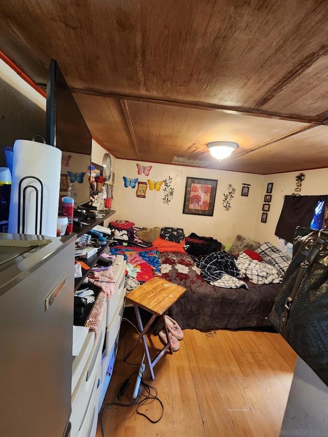 bedroom with hardwood / wood-style floors and wood ceiling