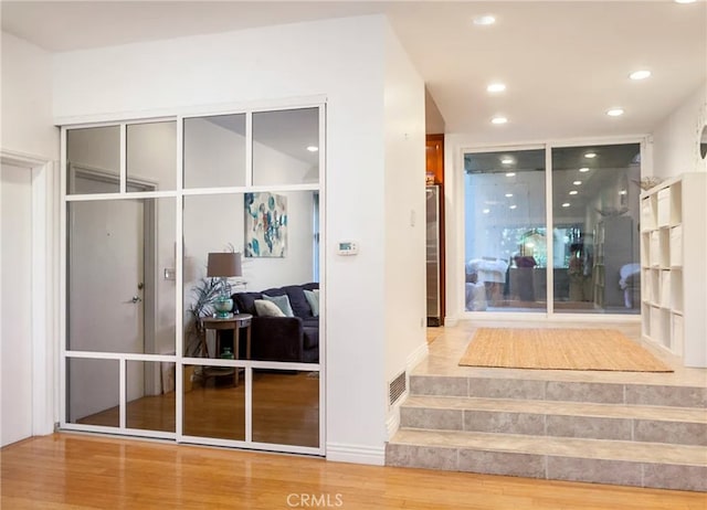 mudroom with wood-type flooring