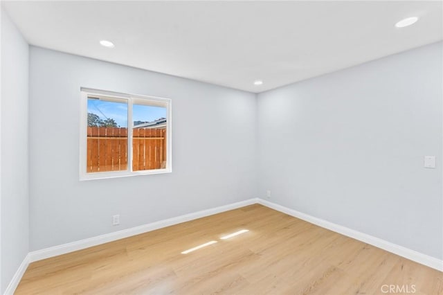 empty room with hardwood / wood-style flooring