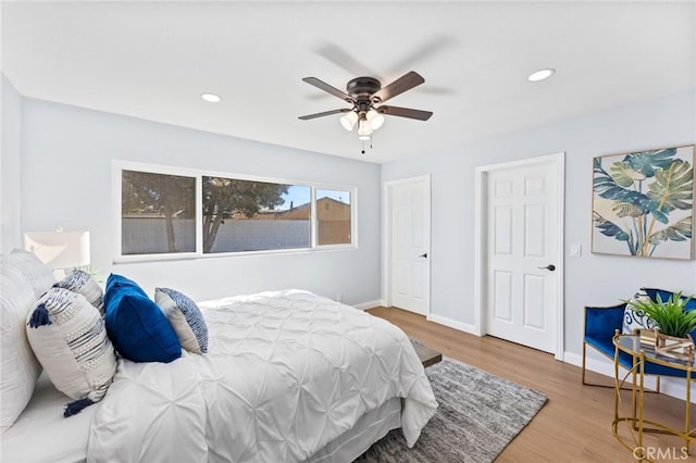 bedroom with ceiling fan and hardwood / wood-style floors