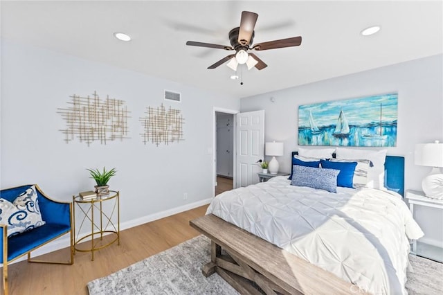 bedroom with hardwood / wood-style floors and ceiling fan