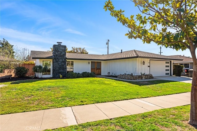 ranch-style home with a garage and a front lawn