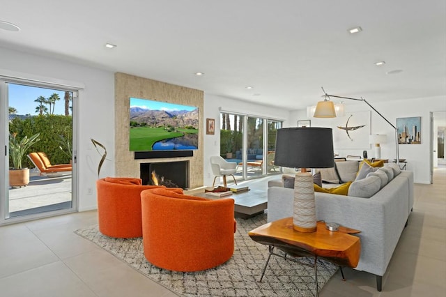 living room featuring a large fireplace and a wealth of natural light