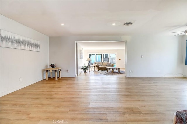 unfurnished room with ceiling fan and light wood-type flooring